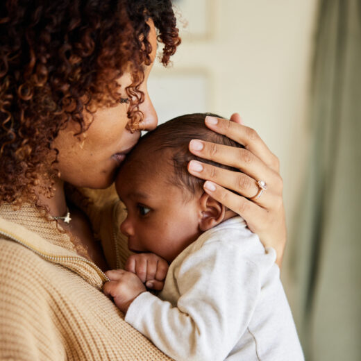 mother kissing babies forehead.